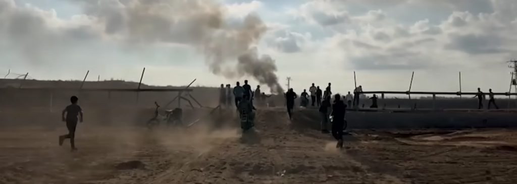Militanti di Hamas mentre sfondano la recinzione del confine tra Israele e Gaza.