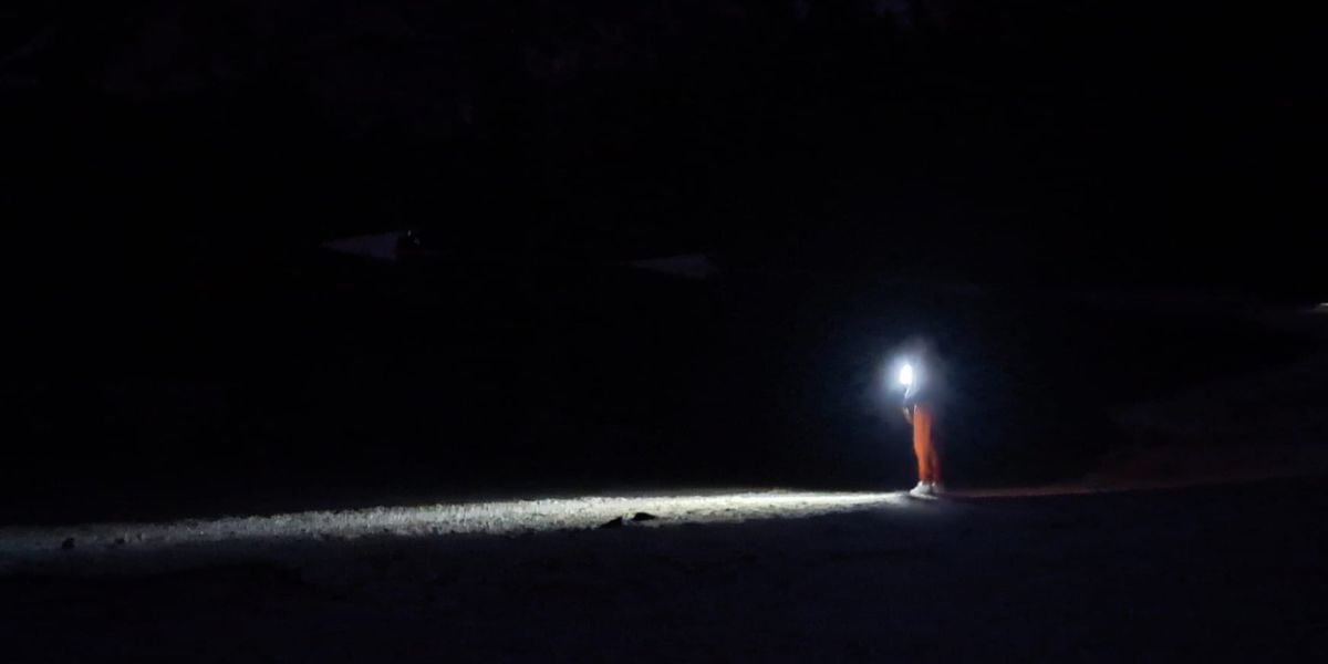 Un uomo con una torcia fa luce nel buio